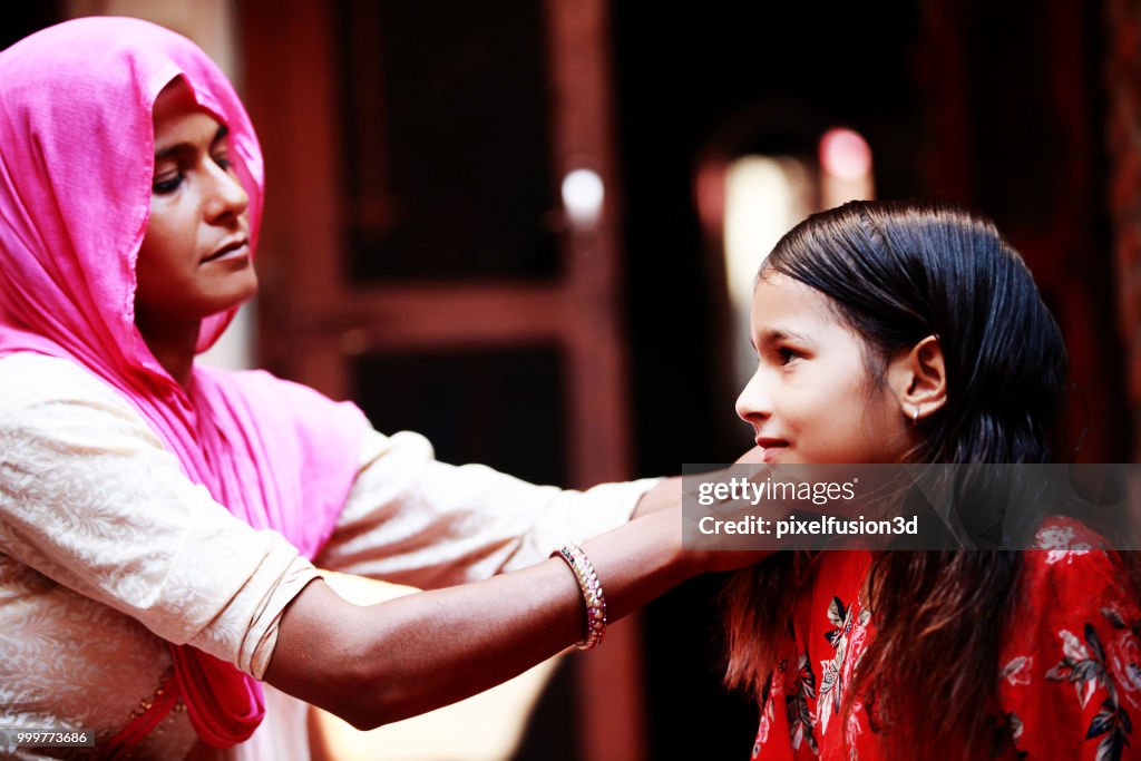 Mother preparing her child for school