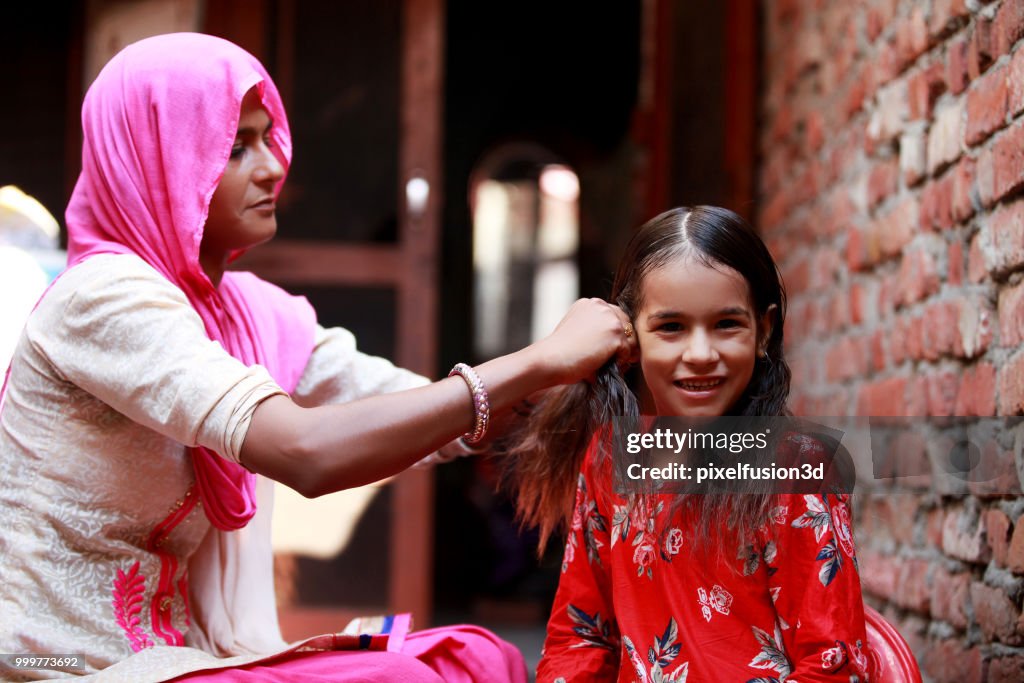 Mother preparing her child for school