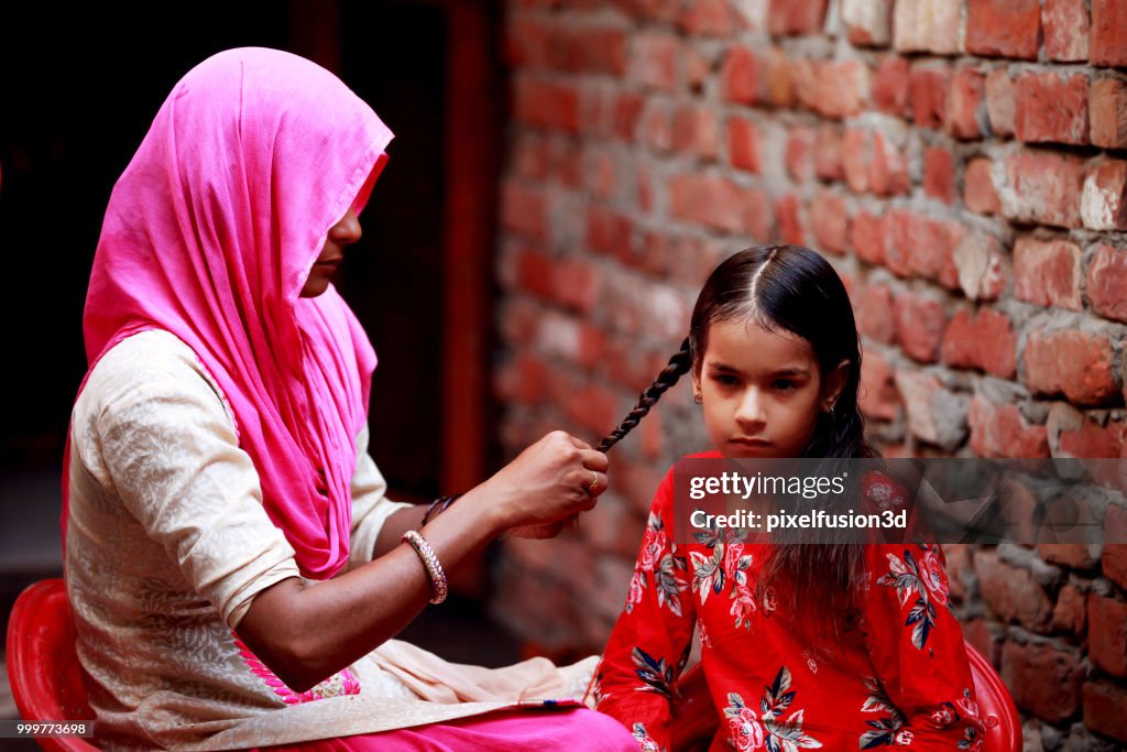 Mother preparing her child for school
