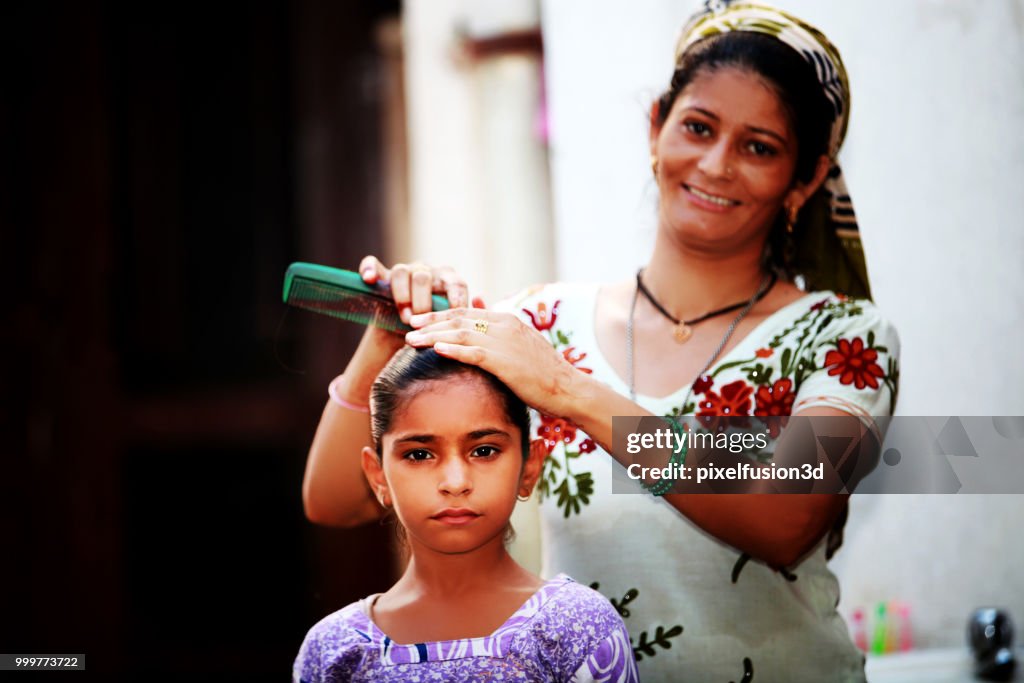 Mother preparing her child for school