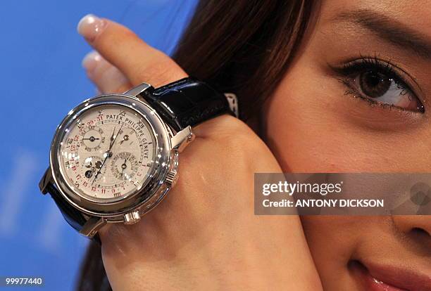 Model Rien holds a Patek Philippe Reference 5002P watch, otherwise known as the Sky Moon Tourbillon, during a Christie's viewing for their Spring...