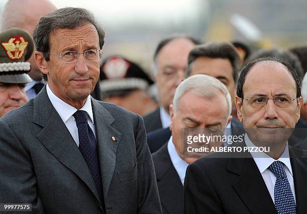 Italy' lower house of parliament president Gianfranco Fini and Italy' senate president Renato Schifani look on as the coffins of two Italian Alpine...