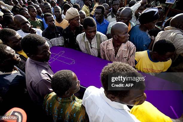 Mourners in the southwestern Sudanese town of Yambio attend on May 18, 2010 the funeral of William Arkangelo, one of four government education...