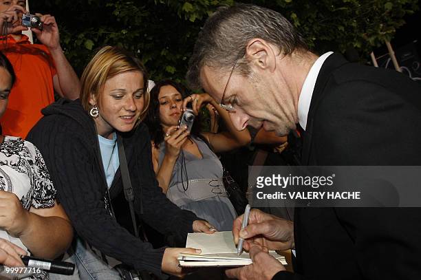 French actor Lambert Wilson signs autographs after the screening of "Des Hommes et des Dieux" presented in competition at the 63rd Cannes Film...