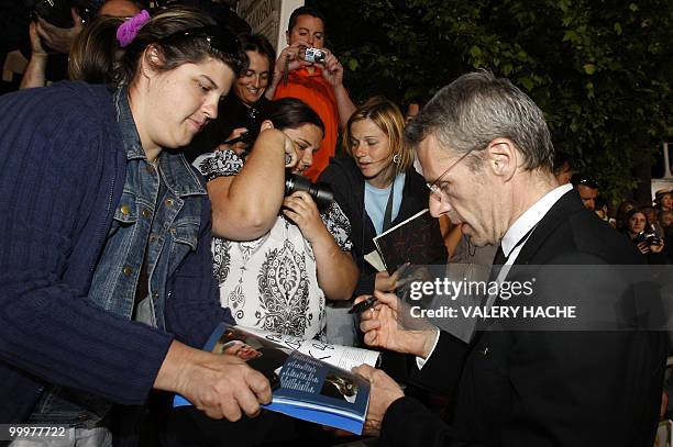 French actor Lambert Wilson signs autographs after the screening of "Des Hommes et des Dieux" presented in competition at the 63rd Cannes Film...