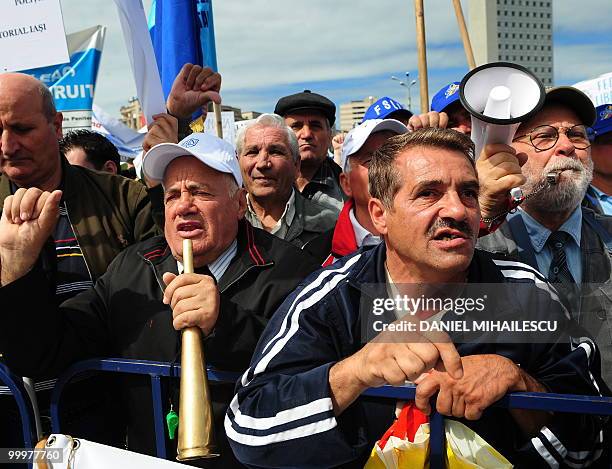 Romanian Trade Union members shout anti-governmental slogans during a mass protest in the front of the Romanian Government headquarters in Bucharest...