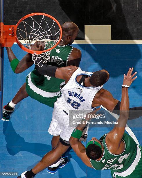 Kevin Garnett and Paul Pierce of the Boston Celtics tangle up in the paint Dwight Howard of the Orlando Magic in Game Two of the Eastern Conference...