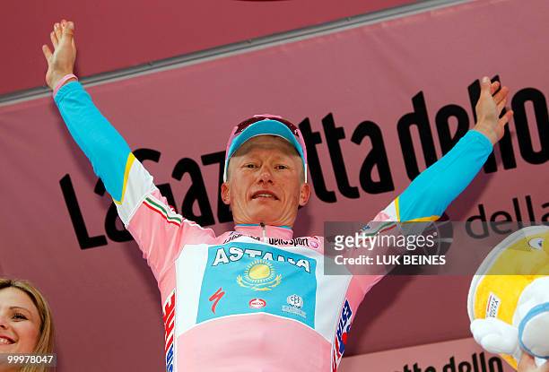 Kazakhstan's Alexandre Vinokourov celebrates retaining the pink jersey of leader on the podium of the tenth stage of the 93rd Giro d'Italia going...