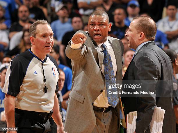 Head coach Doc Rivers of the Boston Celtics makes a point to referee Joe DeRosa as assistant coach Tom Thibodeau looks on during a time out against...