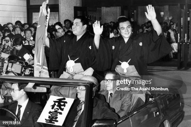 Yokozuna Chiyonofuji celebrates winning the tournament during the victory parade with ozeki Hokutoumi on day fifteen of the Grand Sumo Autumn...
