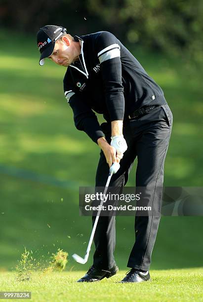 Henrik Stenson of Sweden hits his approach shot on the 1st hole during the Pro-Am round prior to the BMW PGA Championship on the West Course at...