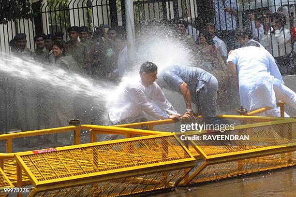Bhartiya Janata Party activist is hit by water cannon unleashed by Delhi police during a protest in New Delhi on May 19, 2010. BJP protesters...
