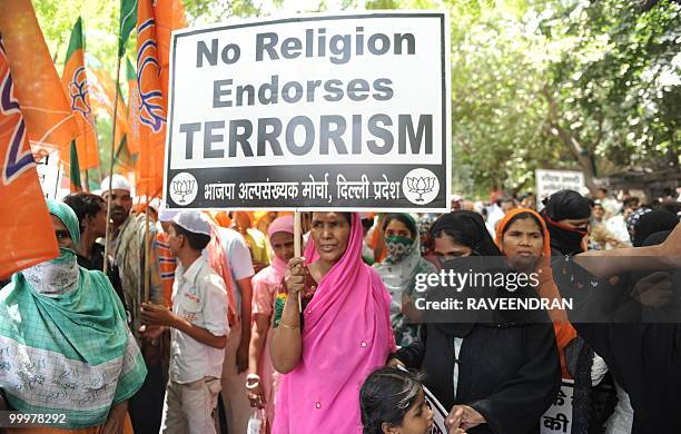 Bhartiya Janata Party activist carries a placard against the Congress led UPA government during a protest in New Delhi on May 19, 2010. BJP...