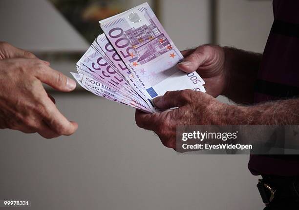 Businessman with 500 Euro banknotes. On May 09, 2010 in Munich, Germany.