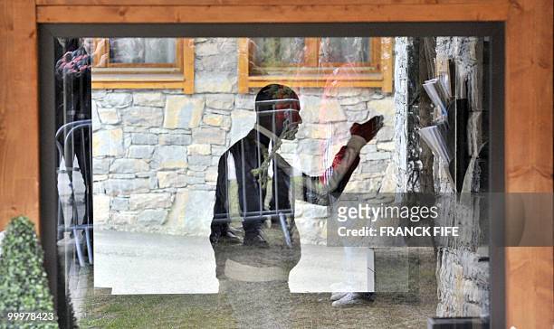 French defender Eric Abidal is pictured through a window aupon his arrival at France's national football team pre-World Cup training camp for the...