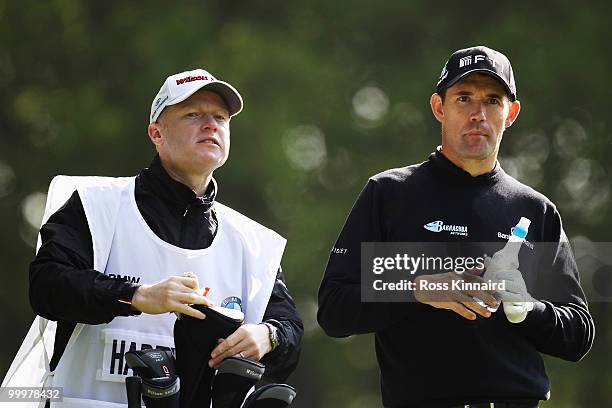Padraig Harrington of Ireland talks with his caddie Ronan Flood during the Pro-Am round prior to the BMW PGA Championship on the West Course at...