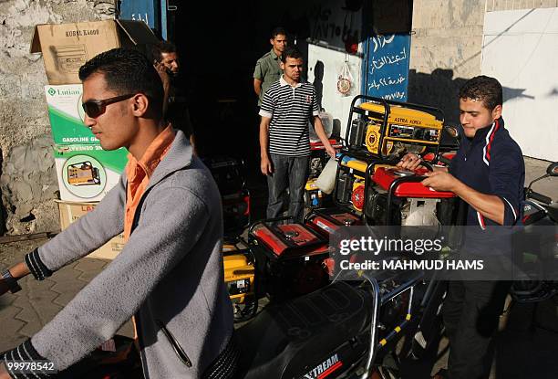 Palestinians buy generators at a shop in Gaza City on May 6, 2010. In war-scarred Gaza, generators are the latest killer, blamed for the deaths of...