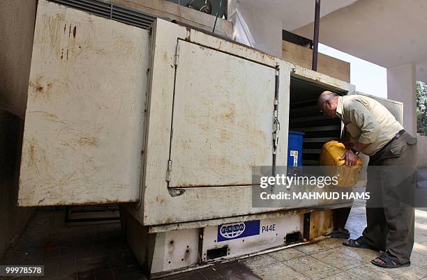Palestinian man fills fuel into a generator in Gaza City on May 6, 2010. In war-scarred Gaza, generators are the latest killer, blamed for the deaths...