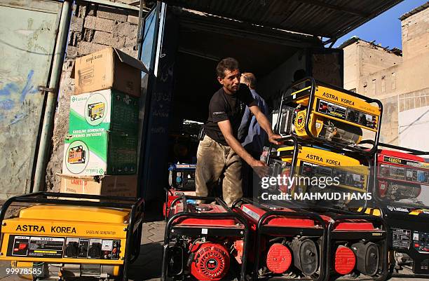 Palestinian man displays generators outside his shop in Gaza City on May 6, 2010. In war-scarred Gaza, generators are the latest killer, blamed for...