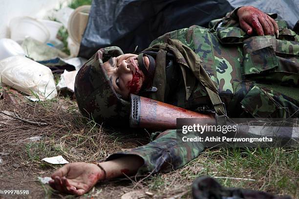 Thai soldier asks for assistance after being hit by a grenade on May 19, 2010 in Bangkok, Thailand. At least 5 people are reported to have died as...