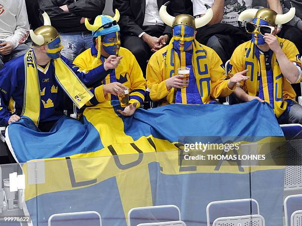 Sweden's fans sit on the tribune during the IIHF Ice Hockey World Championship match Switzerland vs Sweden in the southern German city of Mannheim on...