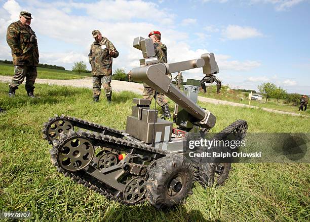 The land-robot "teleMAX" of German company telerob stands next to soldiers during a trial at the German army base on May 18, 2010 in Hammelburg,...