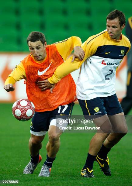 Scott Mcdonald and Lucas Neill of the Socceroos contest for the ball during an Australian Socceroos training session at AAMI Park on May 19, 2010 in...