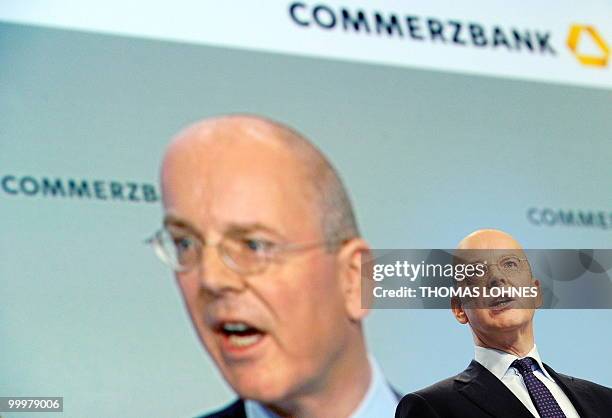 Martin Blessing, chairman of Germany's second biggest bank Commerzbank, is displayed on a giant screen as he speaks to the shareholders during the...