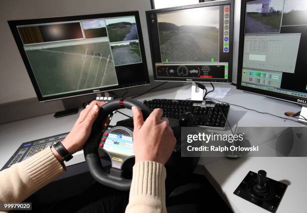 Driver operates a radio-controled land-robot "Gecko" of German company Base Ten drives during a trial at the German army base on May 18, 2010 in...