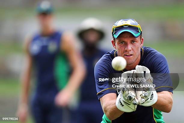 South African cricketer AB de Villiers catches the ball during a practice session at Sir Vivian Richards Stadium in St John's on May 18, 2010. South...