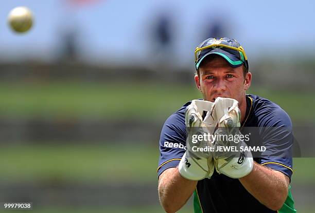 South African cricketer AB de Villiers catches the ball during a practice session at Sir Vivian Richards Stadium in St John's on May 18, 2010. South...