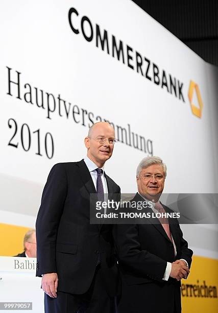 Martin Blessing , chairman of Germany's second biggest bank Commerzbank, and supervisory board chairman Klaus-Peter Mueller pose for photographers...