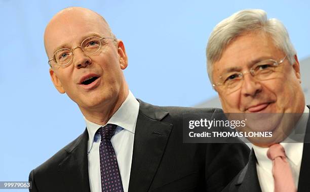 Martin Blessing , chairman of Germany's second biggest bank Commerzbank, and supervisory board chairman Klaus-Peter Mueller pose for photographers...