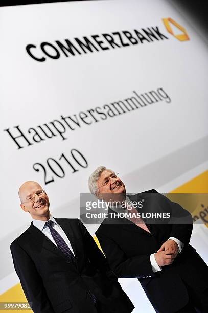 Martin Blessing , chairman of Germany's second biggest bank Commerzbank, and supervisory board chairman Klaus-Peter Mueller pose for photographers...