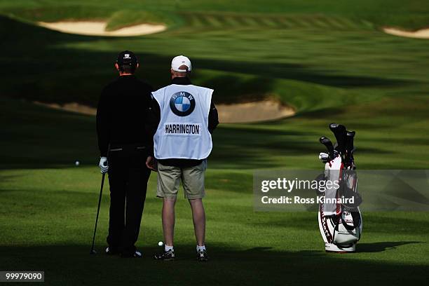 Padraig Harrington of Ireland talks with his caddie Ronan Flood during the Pro-Am round prior to the BMW PGA Championship on the West Course at...