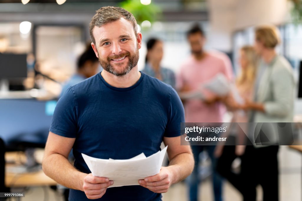 Happy man working at a creative office