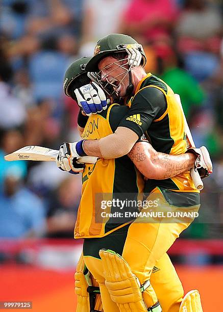 Australian batsman Michael Hussey celebrates with Mitchell Johnson after hitting the winning run during the ICC World Twenty20 second semifinal match...