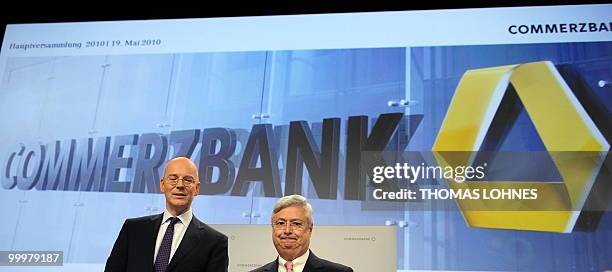 Martin Blessing , chairman of Germany's second biggest bank Commerzbank, and supervisory board chairman Klaus-Peter Mueller pose for photographers...