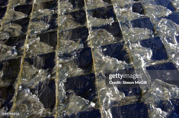 water runs across tiles in a waterfall fountain - australian capital territory stock pictures, royalty-free photos & images