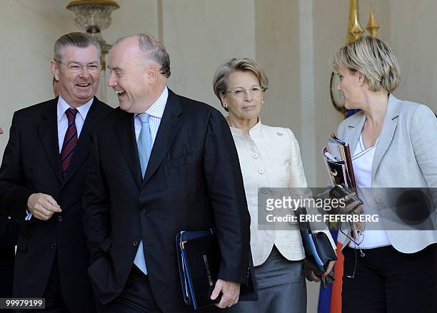 French junior minister responsible for Relations with Parliament Henri de Raincourt shares a joke with Transport minister Dominique Bussereau next to...