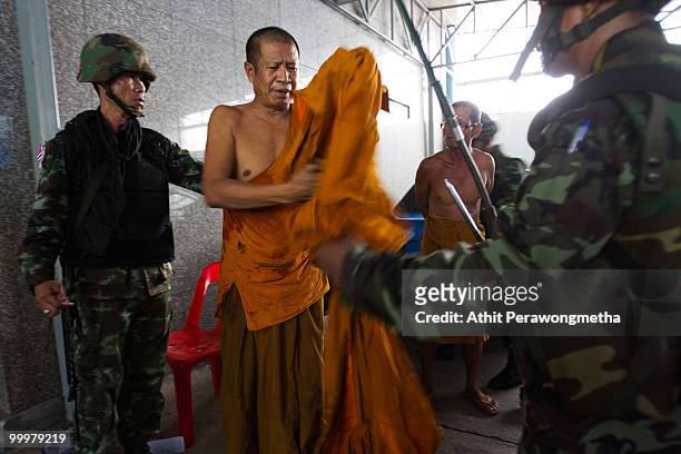Buddhist monks are detained by Thai security forces inside their encampment on May 19, 2010 in Bangkok, Thailand. At least 5 people are reported to...