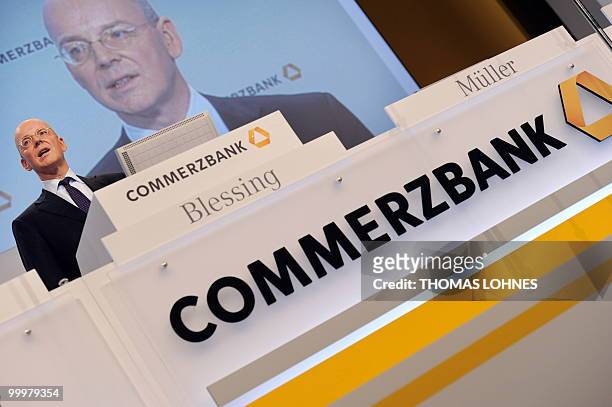 Martin Blessing, chairman of Germany's second biggest bank Commerzbank, is displayed on a giant screen as he speaks to the shareholders during the...