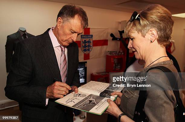 Sir Geoff Hurst signs an autograph prior to the M&S England World Cup Suit Launch on May 19, 2010 in London, England.