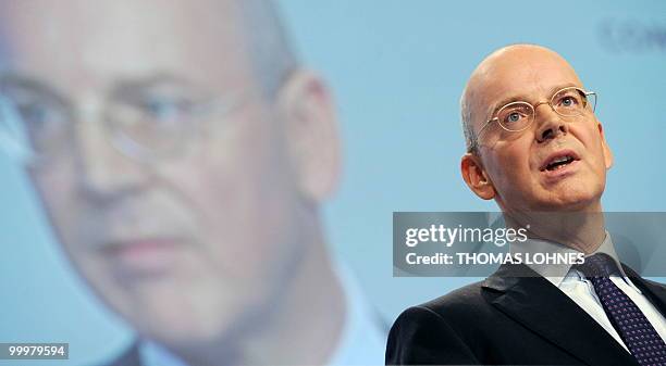 Martin Blessing, chairman of Germany's second biggest bank Commerzbank, is displayed on a giant screen as he speaks to the shareholders during the...