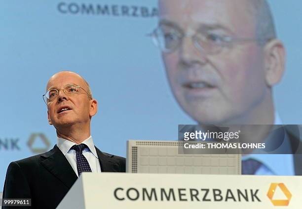 Martin Blessing, chairman of Germany's second biggest bank Commerzbank, is displayed on a giant screen as he speaks to the shareholders during the...