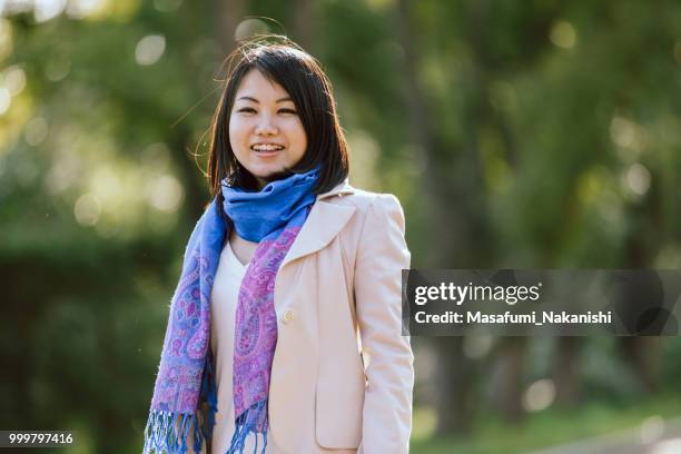 portrait of a healthy asian woman in the park - masafumi nakanishi imagens e fotografias de stock