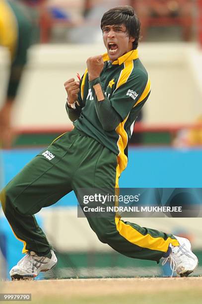 Pakistan cricketer Mohammad Aamer celebrates the wicket of Australian cricketer Shane Watson during the ICC World Twenty20 second semifinal match...