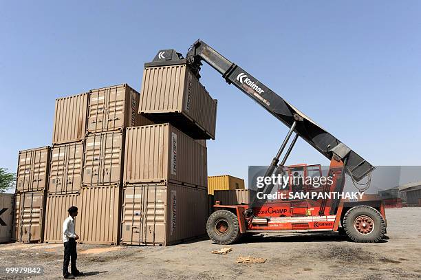 Mobile crane stacks shipping containers at the Inland Container Depot in Sanand, some 30 kms from Ahmedabad, on May 19, 2010. The Thar Dry Port is an...