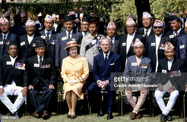 Queen Elizabeth ll and Prince Philip, Duke of Edinburgh pose with Gurkhas during an official visit to Nepal on February 18, 1986 in Kathmandu, Nepal.