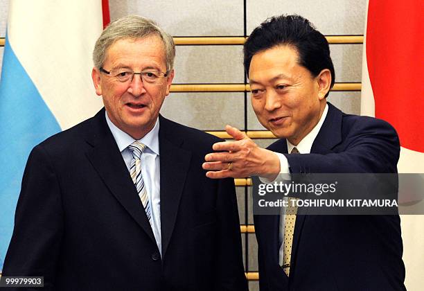 Japanese Prime Minister Yukio Hatoyama shows the way to Luxembourg Prime Minister Jean-Claude Juncker prior to their talks at Hatoyama's official...